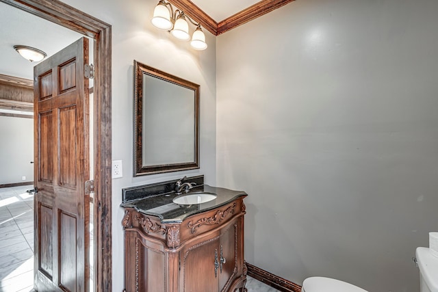 bathroom with toilet, crown molding, tile patterned floors, and vanity