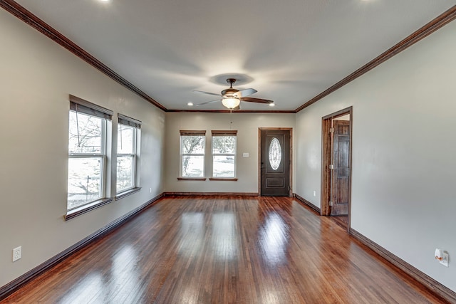 foyer with ceiling fan, a healthy amount of sunlight, crown molding, and hardwood / wood-style floors