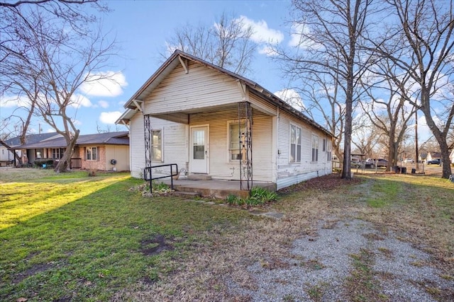 bungalow with a front yard and covered porch