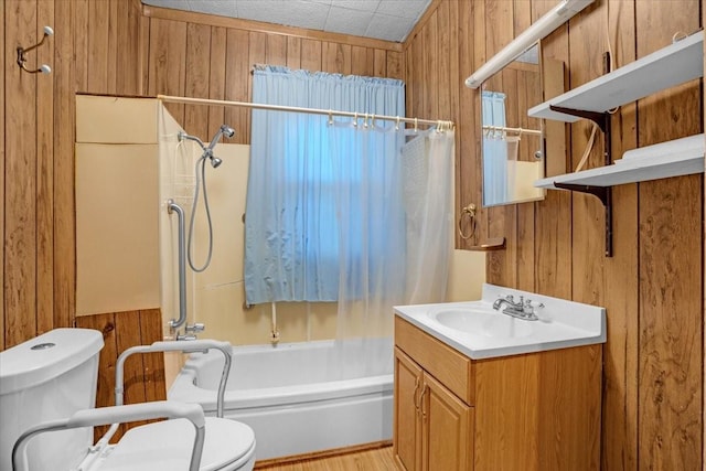 full bathroom featuring toilet, wood walls, shower / bathtub combination with curtain, wood-type flooring, and vanity