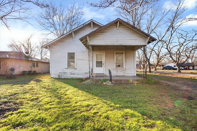 bungalow with a front yard and a porch