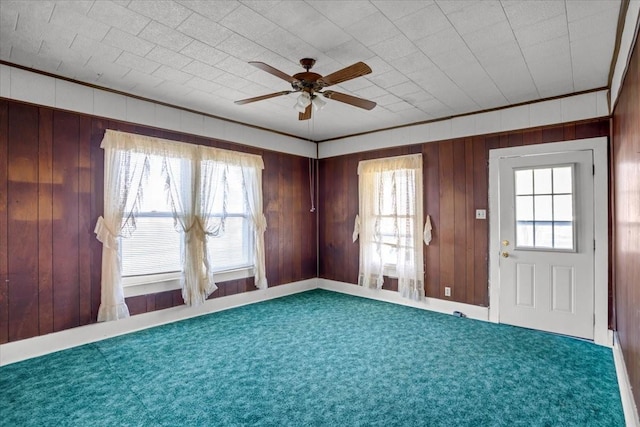 interior space with ceiling fan, carpet, and ornamental molding