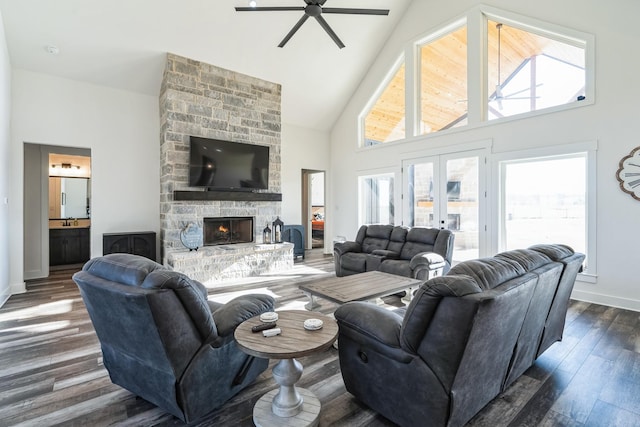 living room featuring ceiling fan, dark hardwood / wood-style floors, high vaulted ceiling, and a fireplace