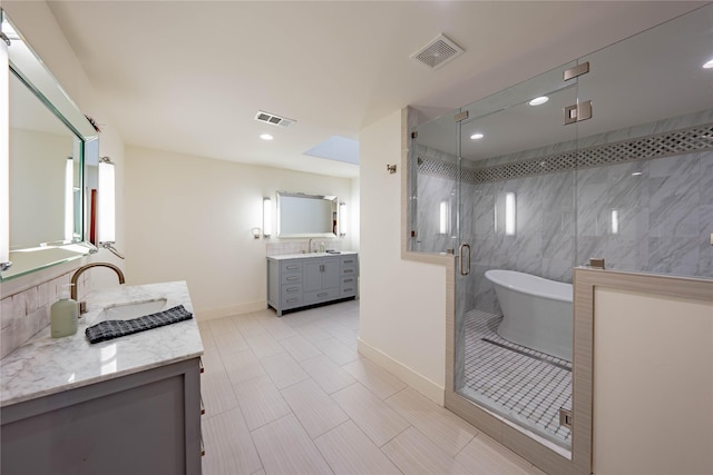 bathroom featuring separate shower and tub, vanity, and tile patterned floors