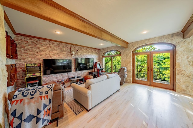 living room with french doors, beamed ceiling, and light hardwood / wood-style floors