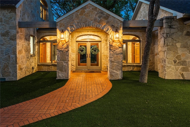 property entrance featuring a lawn and french doors