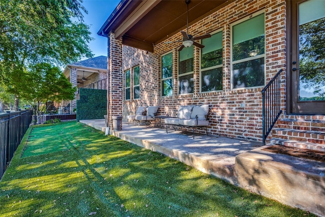 rear view of property with ceiling fan, a yard, and a patio