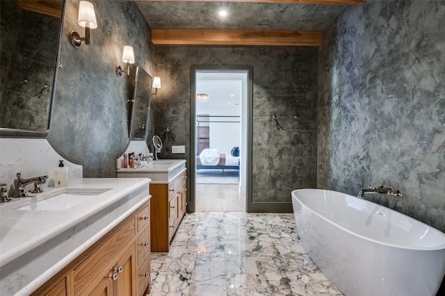 bathroom featuring beam ceiling, a tub to relax in, and vanity