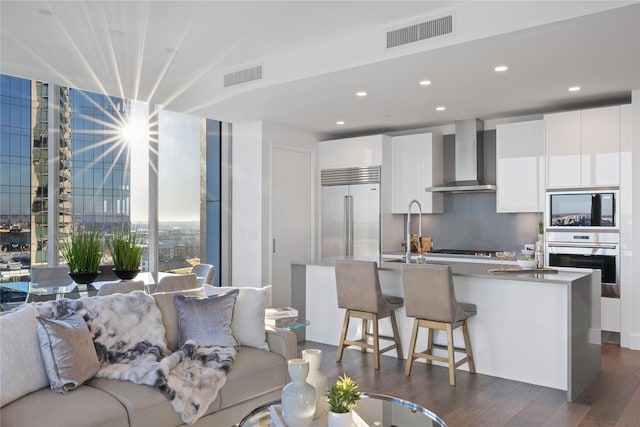 7901 Windrose Ave Unit 1403, Plano, TX 75024 - living area featuring dark wood finished floors and recessed lighting