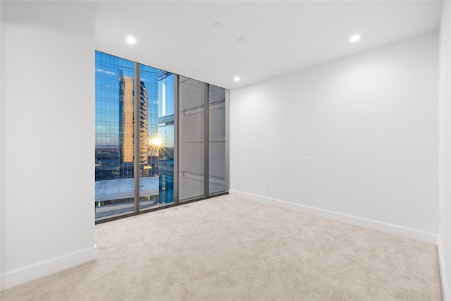 7901 Windrose Ave Unit 1403, Plano, TX 75024 - unfurnished room featuring carpet, baseboards, a wall of windows, and recessed lighting
