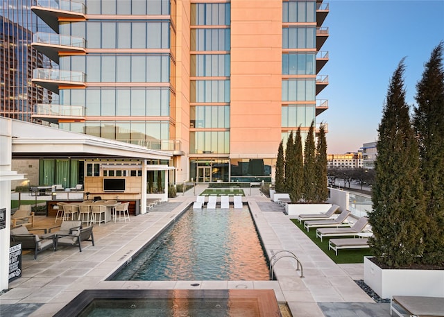 view of pool featuring a patio area, a gazebo, and a bar