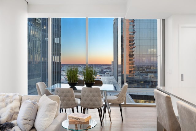 7901 Windrose Ave Unit 1403, Plano, TX 75024 - dining space with wood finished floors and floor to ceiling windows