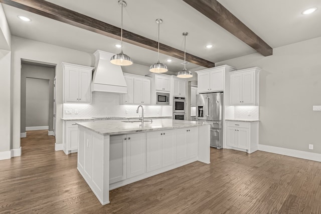 kitchen with a center island with sink, sink, white cabinetry, stainless steel appliances, and custom range hood