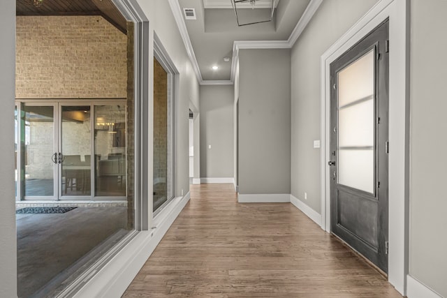 hall featuring wood-type flooring and crown molding