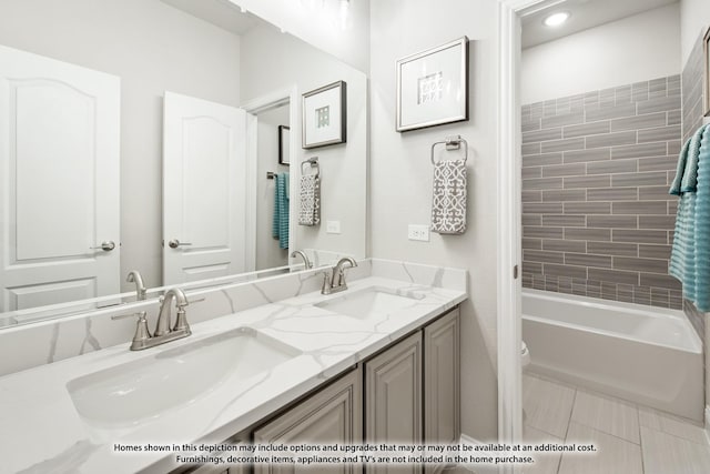 full bathroom featuring toilet, tiled shower / bath, and vanity