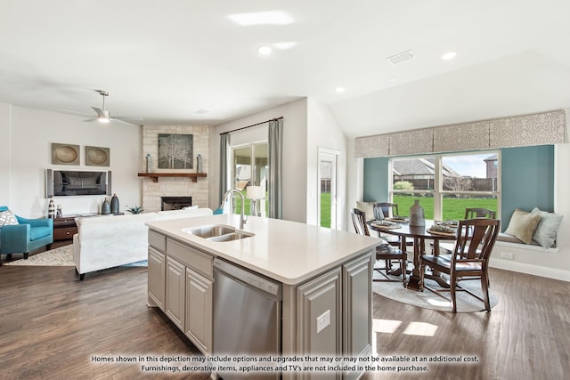 kitchen featuring dishwasher, an island with sink, sink, dark hardwood / wood-style floors, and ceiling fan