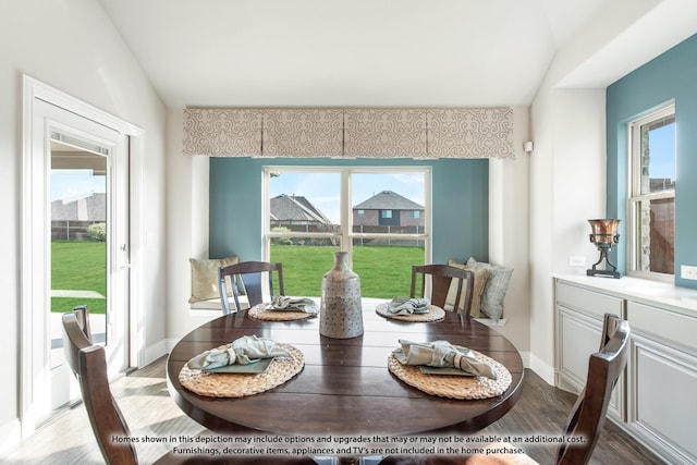 dining area with vaulted ceiling and hardwood / wood-style flooring