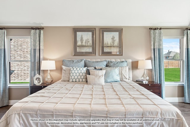 bedroom with multiple windows and hardwood / wood-style floors