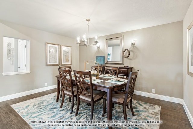 dining space featuring dark wood-type flooring and an inviting chandelier