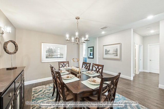 dining space featuring dark hardwood / wood-style floors and a chandelier