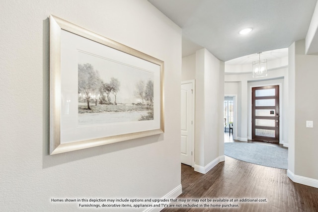 entrance foyer with dark hardwood / wood-style flooring and a chandelier