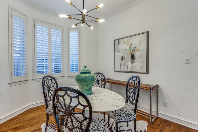 dining area featuring a chandelier, crown molding, and hardwood / wood-style floors