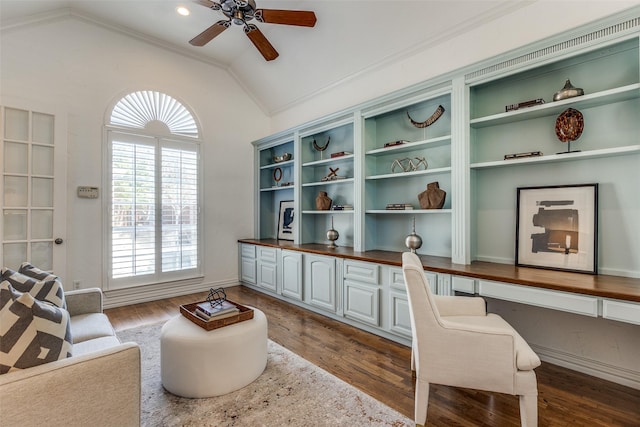 sitting room with ceiling fan, dark hardwood / wood-style floors, ornamental molding, and vaulted ceiling