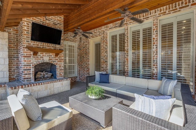 view of patio featuring an outdoor living space with a fireplace and ceiling fan