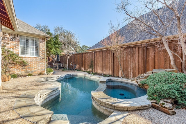 view of swimming pool with an in ground hot tub