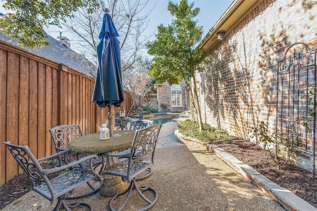 view of patio / terrace with a fenced in pool