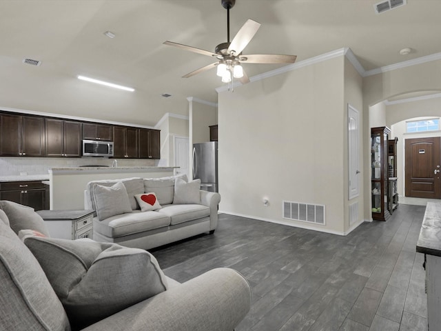 living room featuring ornate columns, ornamental molding, dark hardwood / wood-style floors, and ceiling fan