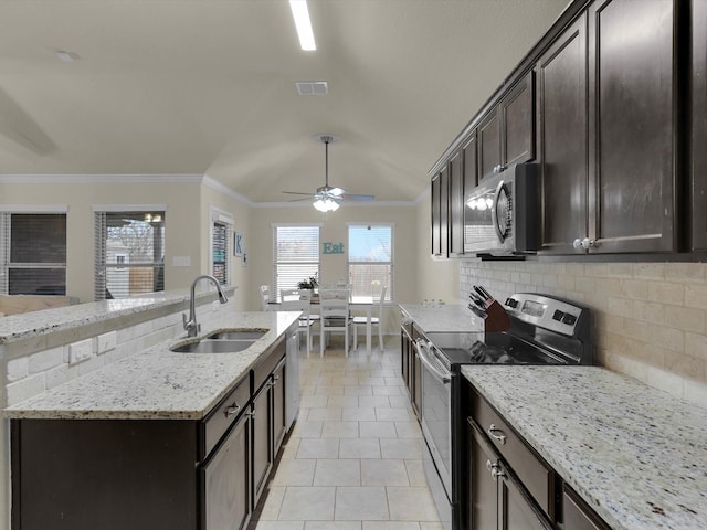 kitchen with visible vents, crown molding, decorative backsplash, appliances with stainless steel finishes, and a sink