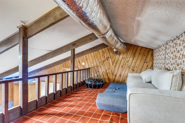 interior space with lofted ceiling with beams and wood walls