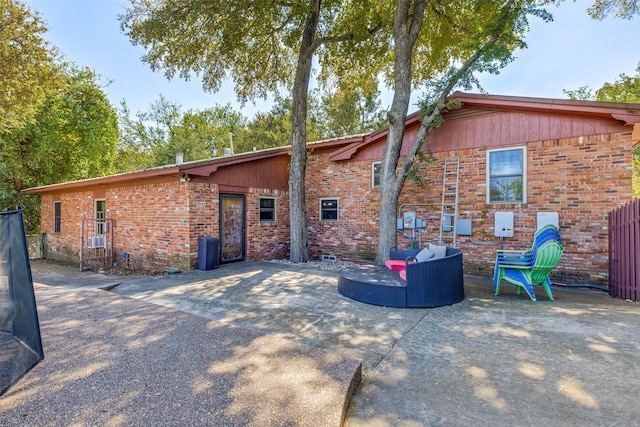 rear view of property featuring an outdoor living space and a patio