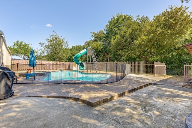 view of swimming pool with a playground