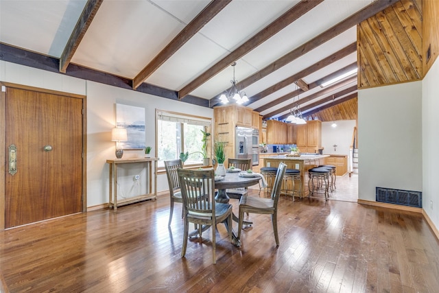 dining area featuring high vaulted ceiling, dark hardwood / wood-style floors, beamed ceiling, and a chandelier