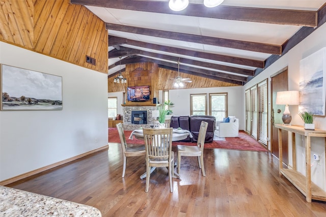 dining room featuring ceiling fan, lofted ceiling with beams, a wealth of natural light, and wood-type flooring