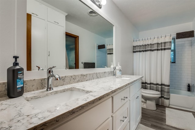 full bathroom with toilet, shower / tub combo, hardwood / wood-style floors, and vanity