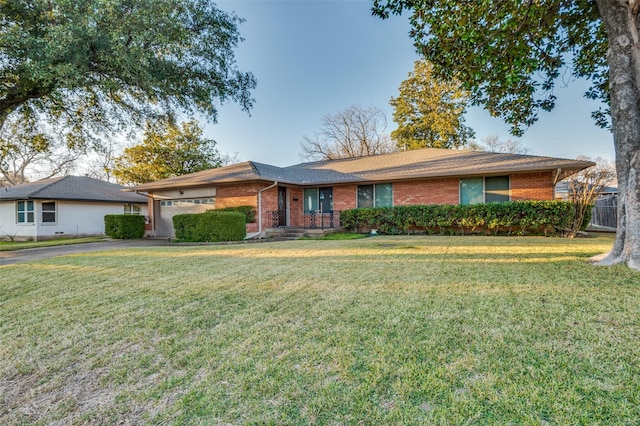 ranch-style home featuring a front lawn and a garage