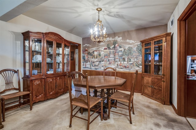 carpeted dining area featuring an inviting chandelier