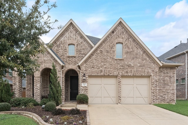 french provincial home featuring a garage