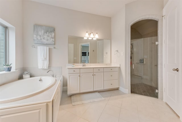 bathroom featuring vanity, independent shower and bath, and tile patterned floors