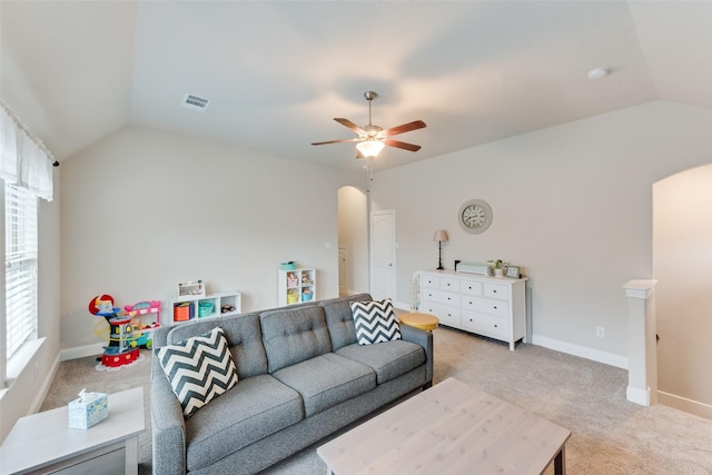 carpeted living room with vaulted ceiling and ceiling fan