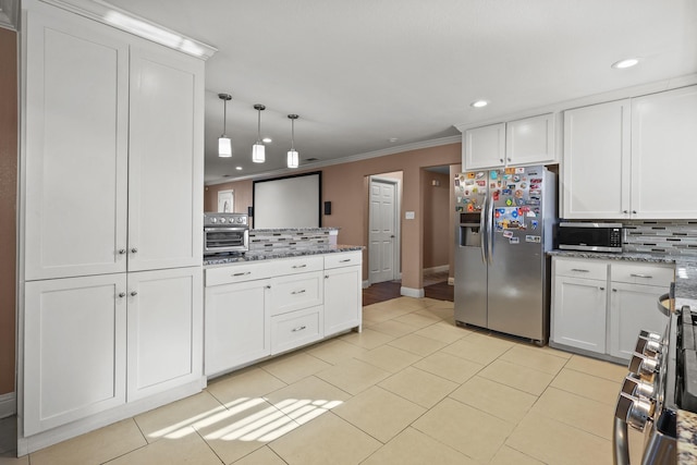 kitchen featuring white cabinets, appliances with stainless steel finishes, decorative light fixtures, tasteful backsplash, and ornamental molding