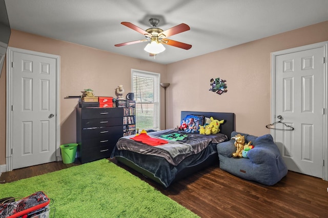 bedroom featuring ceiling fan and dark wood-type flooring