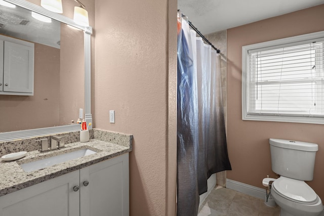 bathroom featuring toilet, vanity, and curtained shower