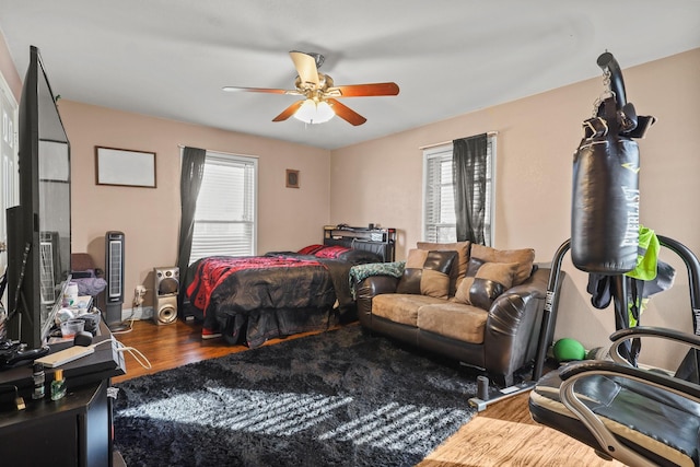 bedroom with ceiling fan and hardwood / wood-style flooring