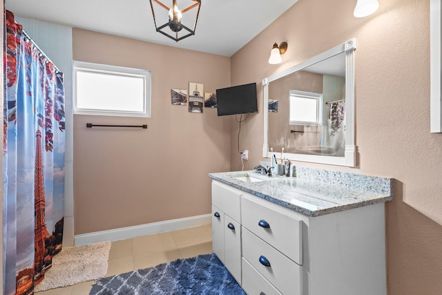 bathroom featuring a shower with shower curtain, tile patterned flooring, plenty of natural light, and vanity