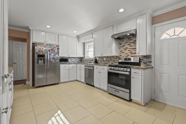 kitchen featuring exhaust hood, appliances with stainless steel finishes, and white cabinetry