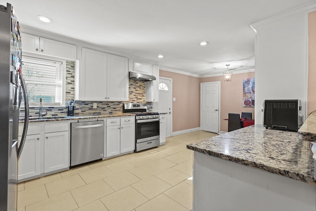 kitchen featuring stainless steel appliances, sink, white cabinets, and light stone countertops